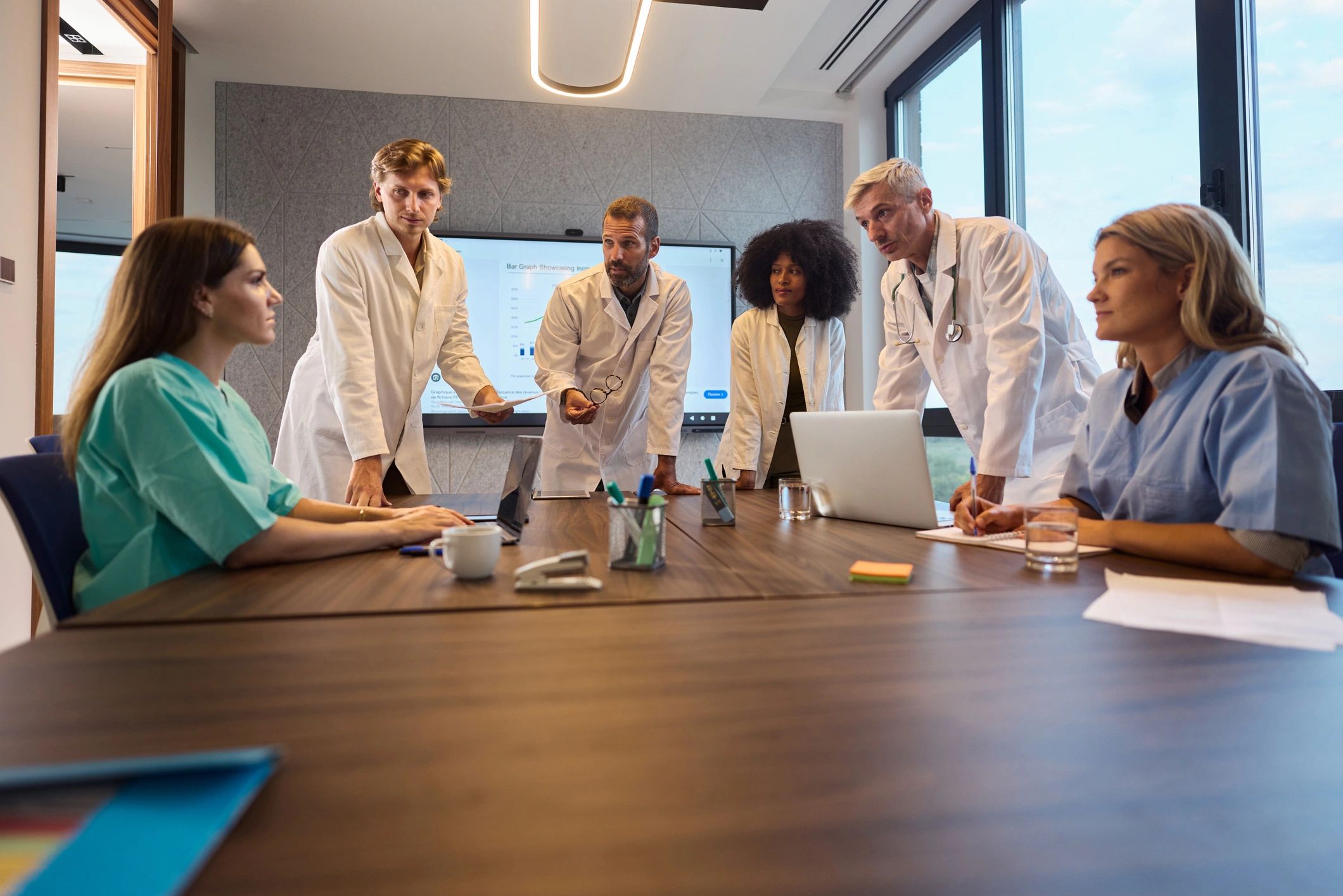 Clinicians collaborating in a meeting, representing multidisciplinary care and research